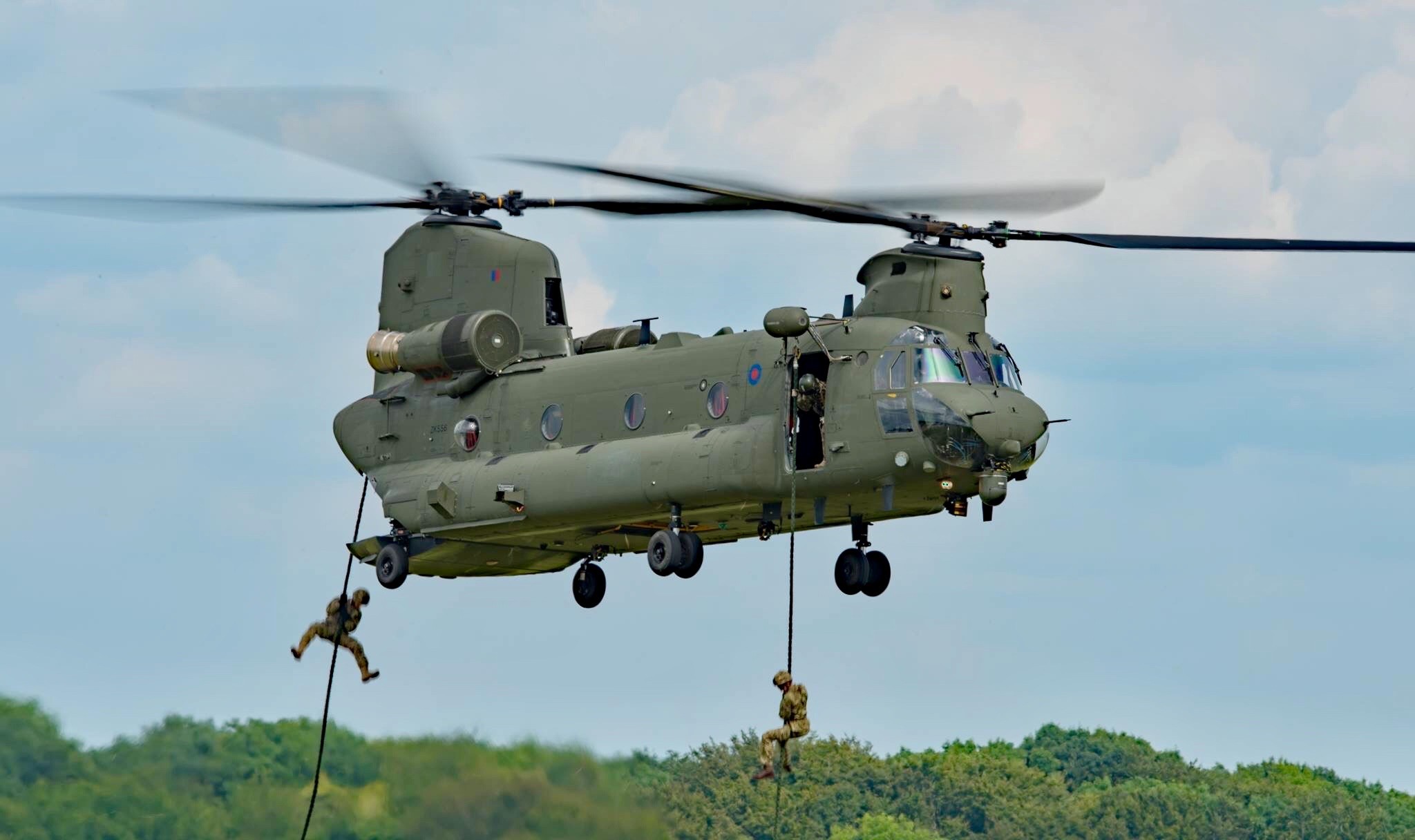 A Chinook helicopter is pictured during fast rope training with live troops 