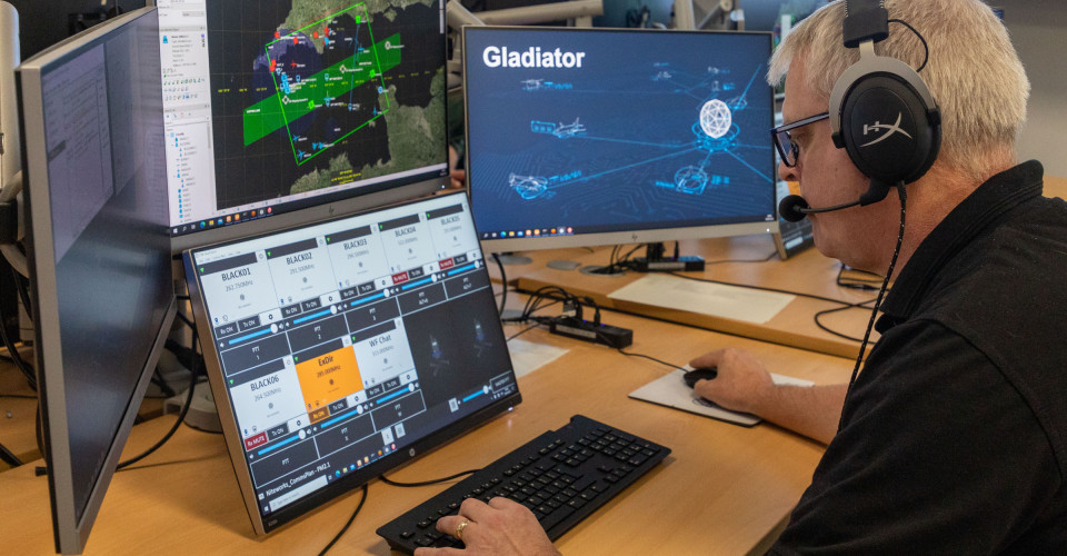 A member of Inzpire's White Force Team operates multiple screens at the ABTC