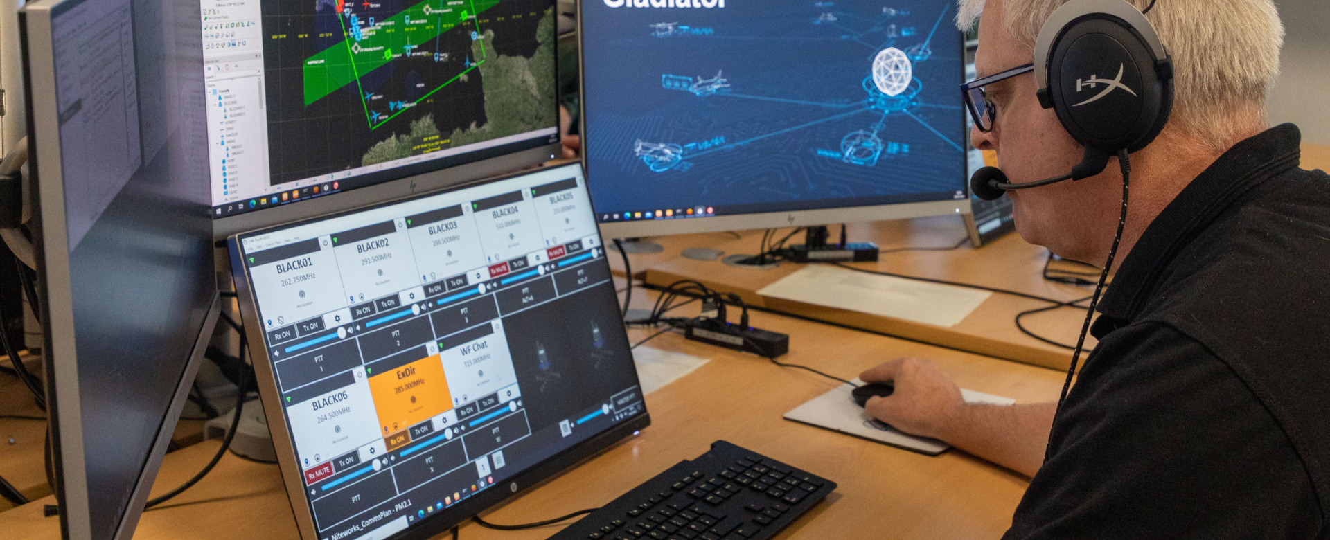 A member of Inzpire's White Force Team operates multiple screens at the ABTC