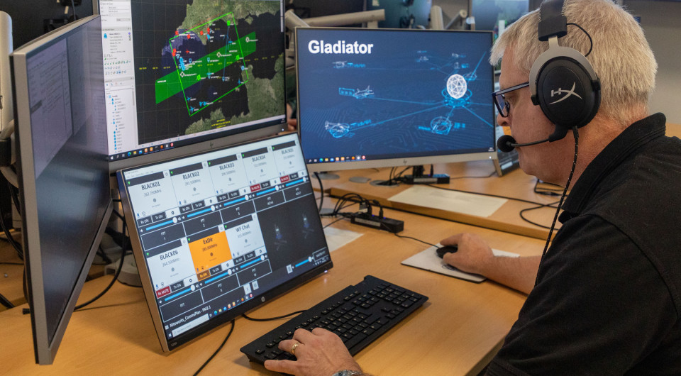 A member of Inzpire's White Force Team operates multiple screens at the ABTC