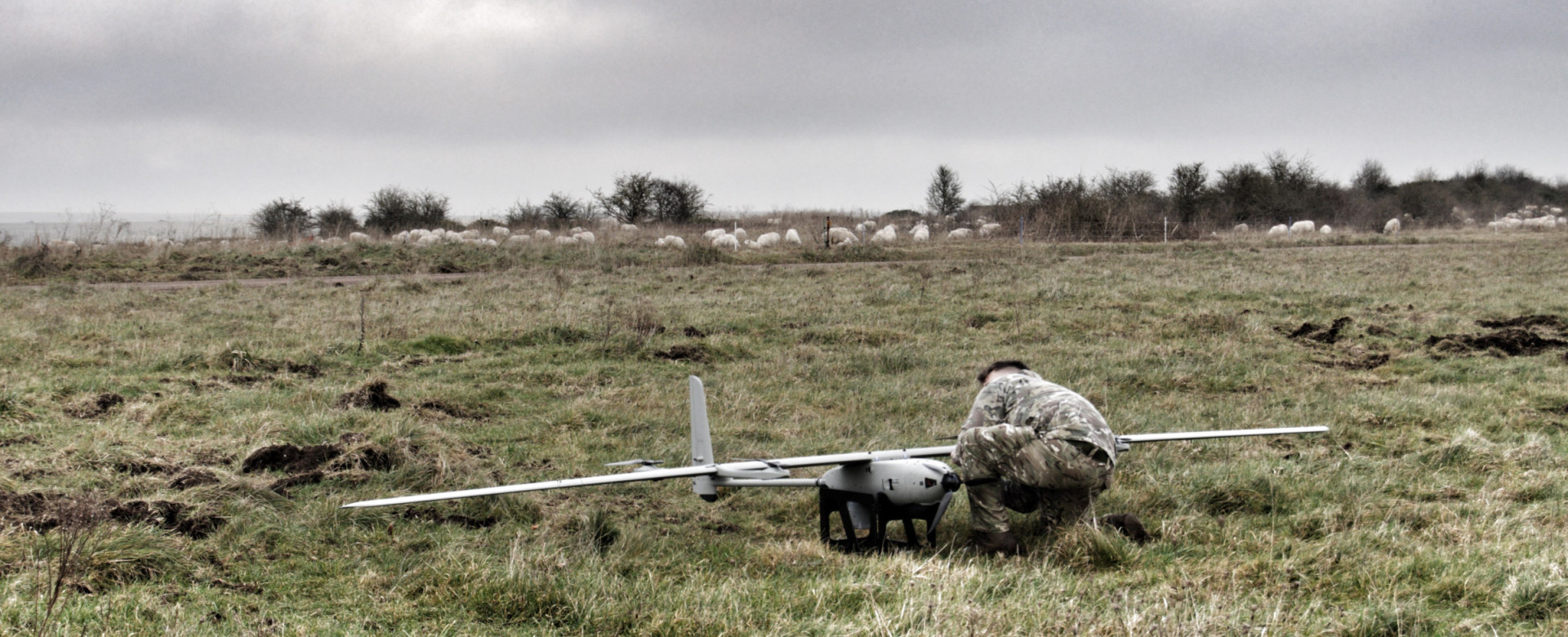 A member of the British Army conducts pre-flight checks on the EAGLE VXE30 drone