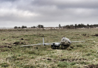 A member of the British Army conducts pre-flight checks on the EAGLE VXE30 drone